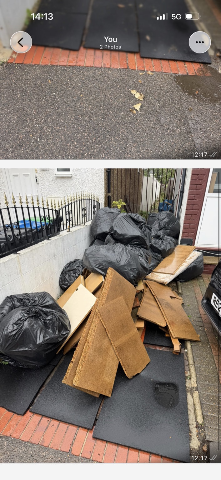 Bagged rubbish and broken furniture boards awaiting collection beside a front garden wall.